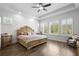 Bright main bedroom features hardwood floors, neutral paint, and bright windows with views at 14855 Renaissance Ave, Odessa, FL 33556
