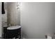 Powder room showcasing decorative mirror tile and modern sink fixtures at 14855 Renaissance Ave, Odessa, FL 33556