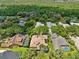 An aerial view of a private luxury home with a pool, solar panels, and green surroundings at 15110 Kestrelglen Way, Lithia, FL 33547