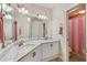 Bright bathroom with double vanity, marble countertop, and gold hardware at 15110 Kestrelglen Way, Lithia, FL 33547