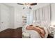 Bright bedroom featuring hardwood floors, a ceiling fan, and a walk-in closet at 15110 Kestrelglen Way, Lithia, FL 33547