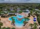 Aerial view of the community pool with mature landscaping, waterslides, seating, and splash-pad area at 15110 Kestrelglen Way, Lithia, FL 33547