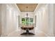 The formal dining room has travertine columns and a view to the manicured greenery at 15110 Kestrelglen Way, Lithia, FL 33547