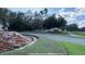 Beautiful entrance to Fish Hawk Trails with lush landscaping and a waterfall feature in a desirable Tampa, Florida neighborhood at 15110 Kestrelglen Way, Lithia, FL 33547