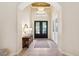 A grand foyer with a high ceiling, tiled flooring, and a decorative mirror at 15110 Kestrelglen Way, Lithia, FL 33547