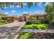 Beautiful single-story home featuring a red brick drive, barrel tile roof and manicured lawn at 15110 Kestrelglen Way, Lithia, FL 33547