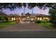 Stunning single-story home featuring a red brick drive, barrel tile roof and lush landscaping at 15110 Kestrelglen Way, Lithia, FL 33547