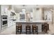 The gourmet kitchen features an island bar with seating, custom cabinetry, and stainless appliances at 15110 Kestrelglen Way, Lithia, FL 33547