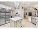 Well-lit kitchen with stainless steel appliances, island, and seamless flow to living spaces at 15110 Kestrelglen Way, Lithia, FL 33547