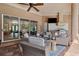 Relaxing outdoor lanai featuring comfortable seating, a grill, and a TV for entertaining guests at 15110 Kestrelglen Way, Lithia, FL 33547