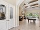 Open-concept living room with a fireplace, a pool table, recessed lighting, and access to the lanai at 15110 Kestrelglen Way, Lithia, FL 33547