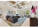 Bright living room features a decorative ceiling and an open concept layout at 15110 Kestrelglen Way, Lithia, FL 33547