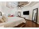 Bright main bedroom featuring hardwood floors, trey ceilings, and plenty of natural light at 15110 Kestrelglen Way, Lithia, FL 33547