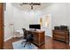 A cozy home office featuring hardwood floors, a ceiling fan and a classic wooden desk at 15110 Kestrelglen Way, Lithia, FL 33547