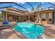 Gorgeous pool area overlooking the manicured backyard, offering both covered and uncovered spaces to enjoy at 15110 Kestrelglen Way, Lithia, FL 33547