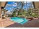 Inviting pool area with a spa, comfortable seating, and a serene backyard setting for outdoor enjoyment at 15110 Kestrelglen Way, Lithia, FL 33547