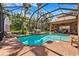 Stunning backyard pool and lanai area, perfect for entertaining and relaxation, with beautiful landscaping at 15110 Kestrelglen Way, Lithia, FL 33547