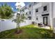 Fenced in backyard with a grassy lawn and a patio dining set for outdoor enjoyment at 1529 N Morgan St, Tampa, FL 33602