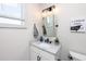 Modern bathroom features a gray vanity, white walls, and a decorative print at 1529 N Morgan St, Tampa, FL 33602