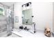 Stylish bathroom featuring modern white vanity, marble tile, a tub-shower, and sleek hardware at 1529 N Morgan St, Tampa, FL 33602