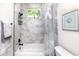 Bright bathroom showcases a tub with stylish marble tile surround and decorative shower curtain at 1529 N Morgan St, Tampa, FL 33602