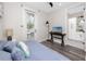 Well-lit bedroom with hardwood floors and access to a tiled bathroom at 1529 N Morgan St, Tampa, FL 33602