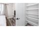 Bedroom with hardwood floors, flatscreen tv on desk and white trim walk-in closet with wire shelves at 1529 N Morgan St, Tampa, FL 33602