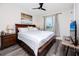 A comfortably appointed bedroom featuring a dark wood bed frame, wood floors, and a ceiling fan at 1529 N Morgan St, Tampa, FL 33602