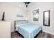 Comfortable bedroom featuring a ceiling fan, a window, and a decorative mirror for a relaxing atmosphere at 1529 N Morgan St, Tampa, FL 33602