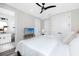 A well-lit bedroom featuring a ceiling fan, walk-in closets, and access to an en-suite bathroom at 1529 N Morgan St, Tampa, FL 33602