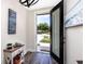Welcoming foyer features wood-look floors and an open door showcasing the outdoor view at 1529 N Morgan St, Tampa, FL 33602