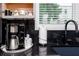 Coffee bar area with stainless steel coffee maker, paper towels, and patterned coffee mugs at 1529 N Morgan St, Tampa, FL 33602