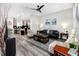 Open-concept living room with sleek leather sofa, modern rug, and adjacent kitchen area at 1529 N Morgan St, Tampa, FL 33602