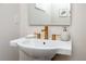 Elegant powder room featuring a pedestal sink with bronze fixtures and decorative accents at 1529 N Morgan St, Tampa, FL 33602