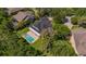 A private backyard oasis featuring a pristine pool and covered patio in a lush, tree-lined neighborhood at 15934 Sorawater Dr, Lithia, FL 33547