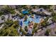 Aerial view of a stunning community pool and lounge area featuring unique rock features, waterfalls and mature landscaping at 15934 Sorawater Dr, Lithia, FL 33547