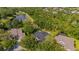 A property featuring a private backyard pool and lush landscaping, nestled within a tranquil, wooded neighborhood at 15934 Sorawater Dr, Lithia, FL 33547