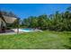 A beautifully landscaped backyard features a sparkling pool and meticulously maintained lawn, perfect for relaxation at 15934 Sorawater Dr, Lithia, FL 33547
