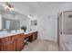 Bathroom with double sinks, ample counter space, soaking tub, and walk-in shower at 15934 Sorawater Dr, Lithia, FL 33547