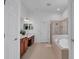 Bright bathroom featuring double vanities and separate shower and tub at 15934 Sorawater Dr, Lithia, FL 33547