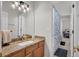 Bathroom vanity featuring granite countertop with stylish sink and a shower/tub at 15934 Sorawater Dr, Lithia, FL 33547