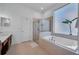 Modern bathroom featuring a large soaking tub and a separate glass-enclosed shower at 15934 Sorawater Dr, Lithia, FL 33547