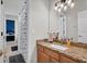 Bathroom vanity featuring granite countertop with stylish sink and cabinet at 15934 Sorawater Dr, Lithia, FL 33547