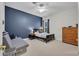 Bedroom with dark accent wall and carpeted floors; features a futon and dresser at 15934 Sorawater Dr, Lithia, FL 33547