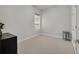 Bedroom with neutral carpet and single window; features an empty room at 15934 Sorawater Dr, Lithia, FL 33547