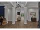 Elegant foyer with high ceilings, columns, and herringbone wood floors, creating a grand entrance at 15934 Sorawater Dr, Lithia, FL 33547