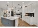 A spacious kitchen featuring a marble island, black backsplash, and modern lighting at 15934 Sorawater Dr, Lithia, FL 33547