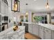 A spacious kitchen featuring a marble island, stainless steel appliances, and modern lighting at 15934 Sorawater Dr, Lithia, FL 33547