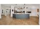 Open kitchen with a large center island, wooden floors, stainless steel appliances, and plenty of natural light at 15934 Sorawater Dr, Lithia, FL 33547