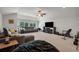 Large living area with plush seating, ample natural light, and home entertainment setup at 15934 Sorawater Dr, Lithia, FL 33547